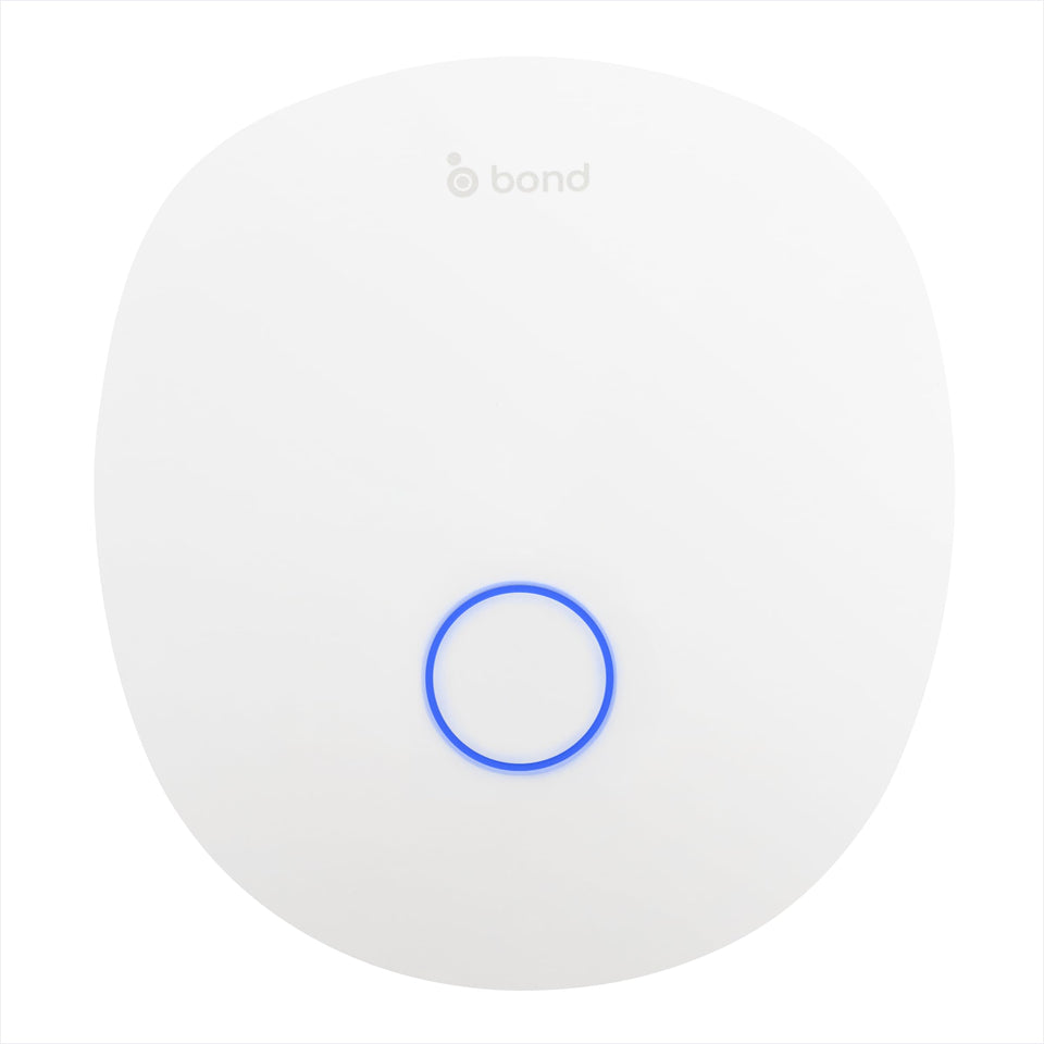 Bond Bridge Pro on wall enabling centralized smart control of fans and shades across rooms.