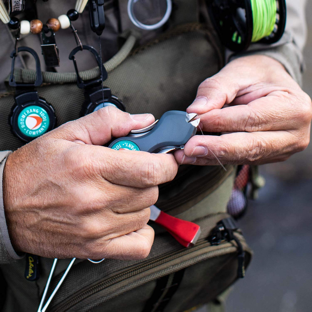 Boomerang Original SNIP shown with carabiner secured to a vest for fast field access.