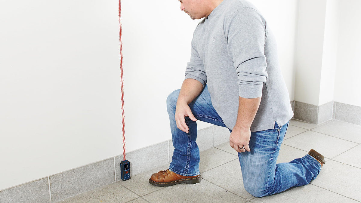Compact Bosch GLM165-22 Blaze with belt clip and pouch for easy transport.