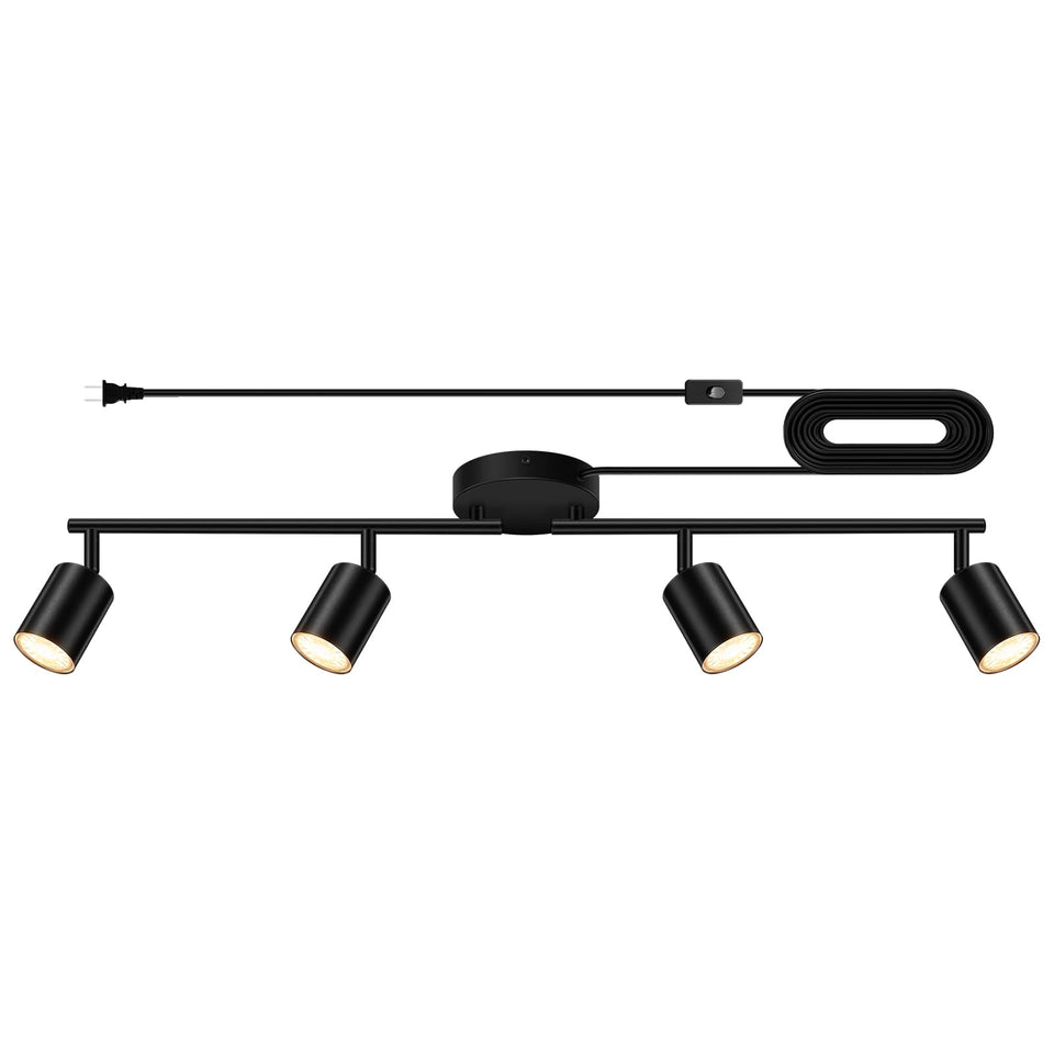Bricosmocon four-light plug-in track lighting on black ceiling for versatile illumination.