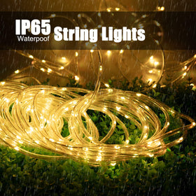 Brightown LED bulbs on copper wire glowing evenly along fence or tree.