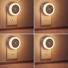 Briignite LED night light four-pack plugged into wall for space-saving illumination.