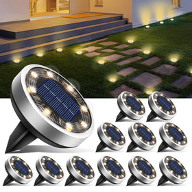 btfarm 8-LED solar ground light along a garden path emits warm white glow