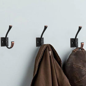CABDM bronze hooks in hallway setting for coats and bags organization.