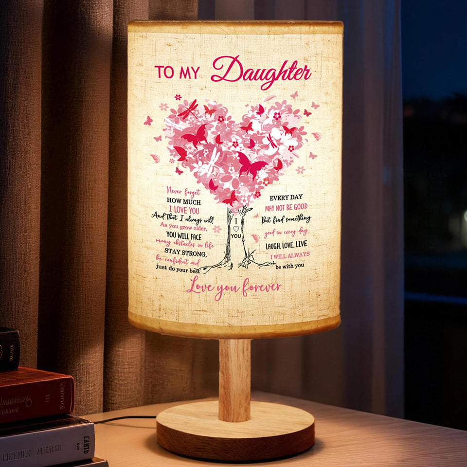 Calibron fabric lamp with wooden stand for a warm, inviting glow.