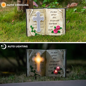 Candieslife cross stake with roses lit at night for peaceful remembrance