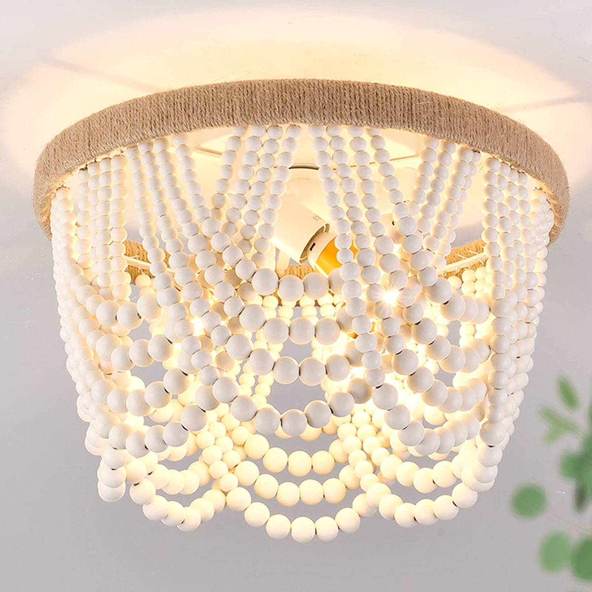 Capslpad wood-beaded flush mount chandelier for ambient dining room lighting.
