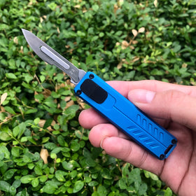 Caressolove blue edc knife beside 10 blades ready for replacements