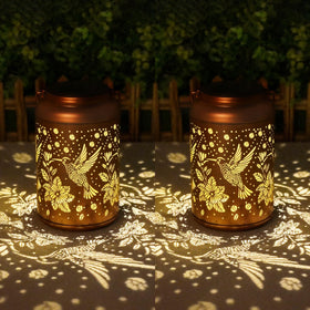 Cawalap hummingbird solar lantern for garden decor provides warm ambient light.