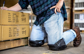 CE' CERDR knee pads on flooring task shielding knees on hard surfaces during installation.