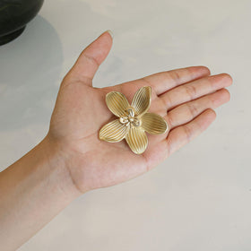 CEYMIO brushed gold flower knob on a vanity or dresser in soft light