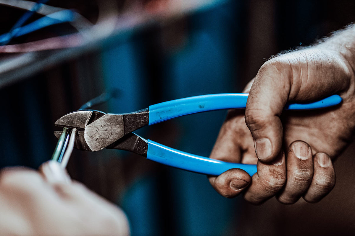 Channellock 338 blue diagonal jaws in action cutting wire cleanly.