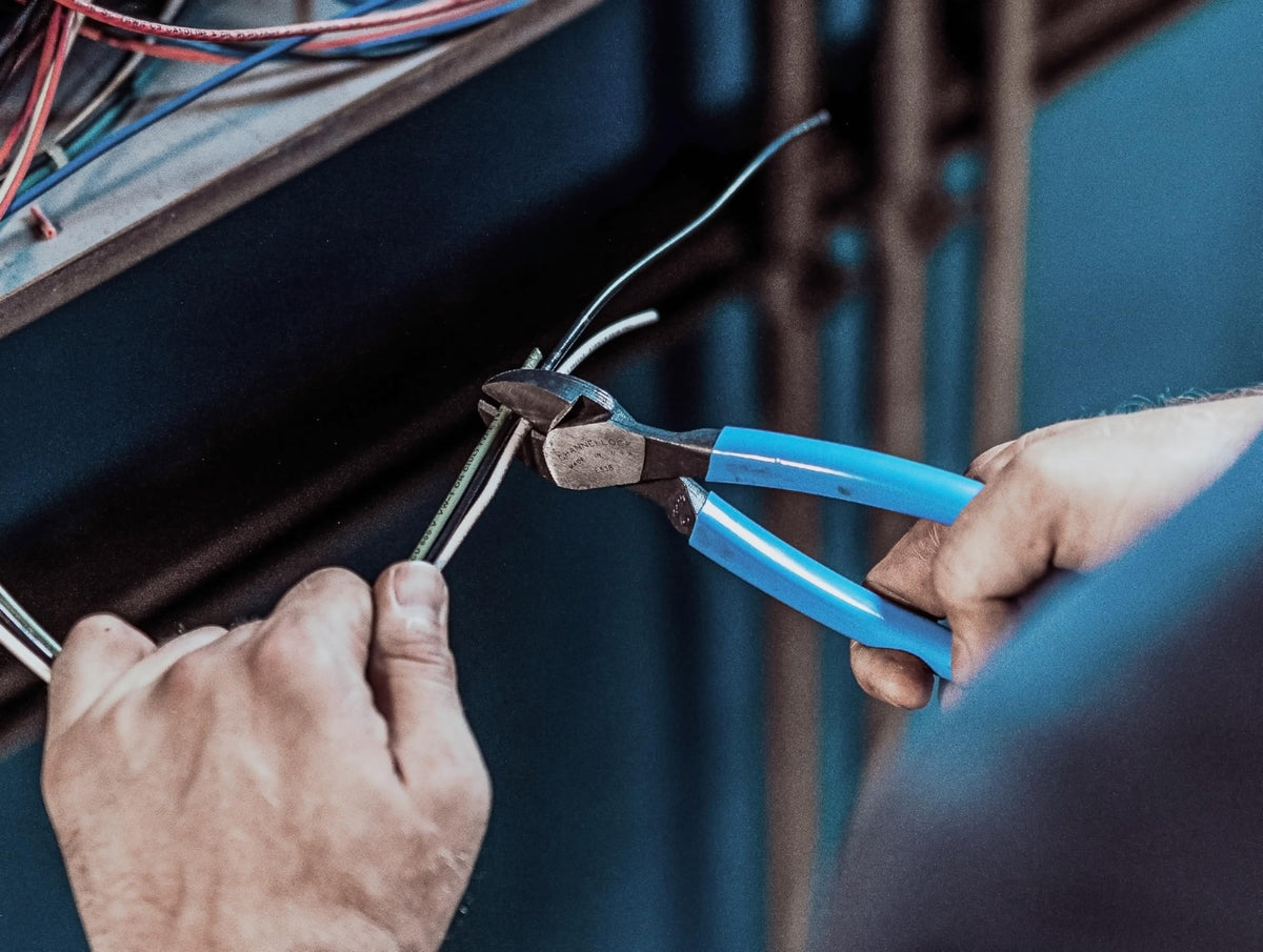 Channellock 338 blue tool in use cutting wires of varying gauges.