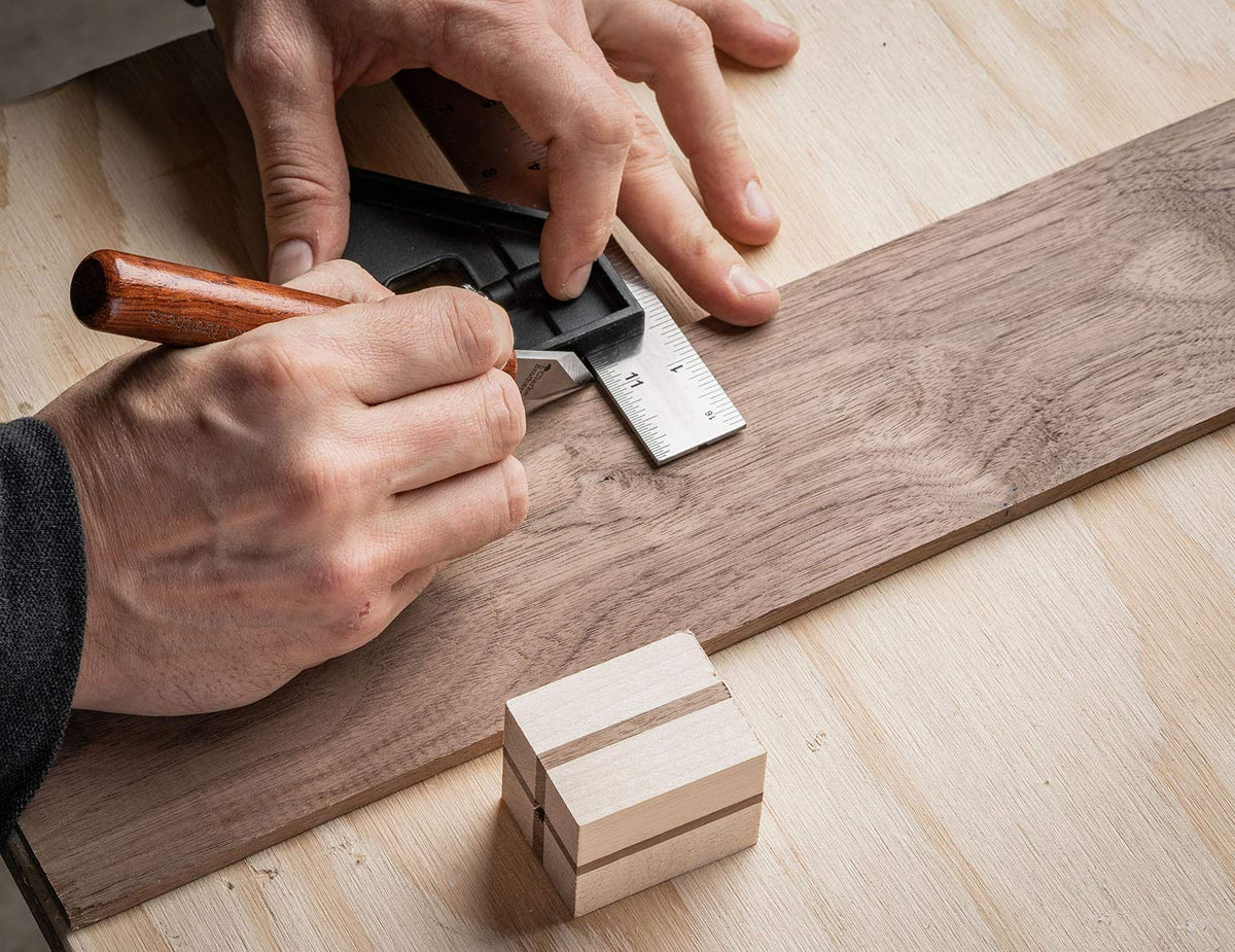Clarke Brothers marking knife on workbench marking a line.