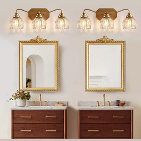 CmnVmn gold vanity light crystal shade delivers warm inviting illumination.