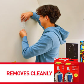 Command folding clothes hanger detaches without holes, allowing reuse.