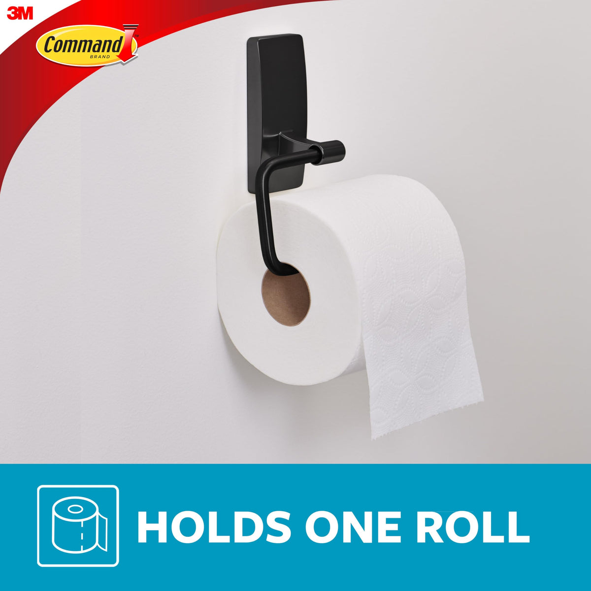 Command toilet paper holder on glass surface demonstrates versatile adhesion.