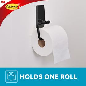 Command toilet paper holder on glass surface demonstrates versatile adhesion.
