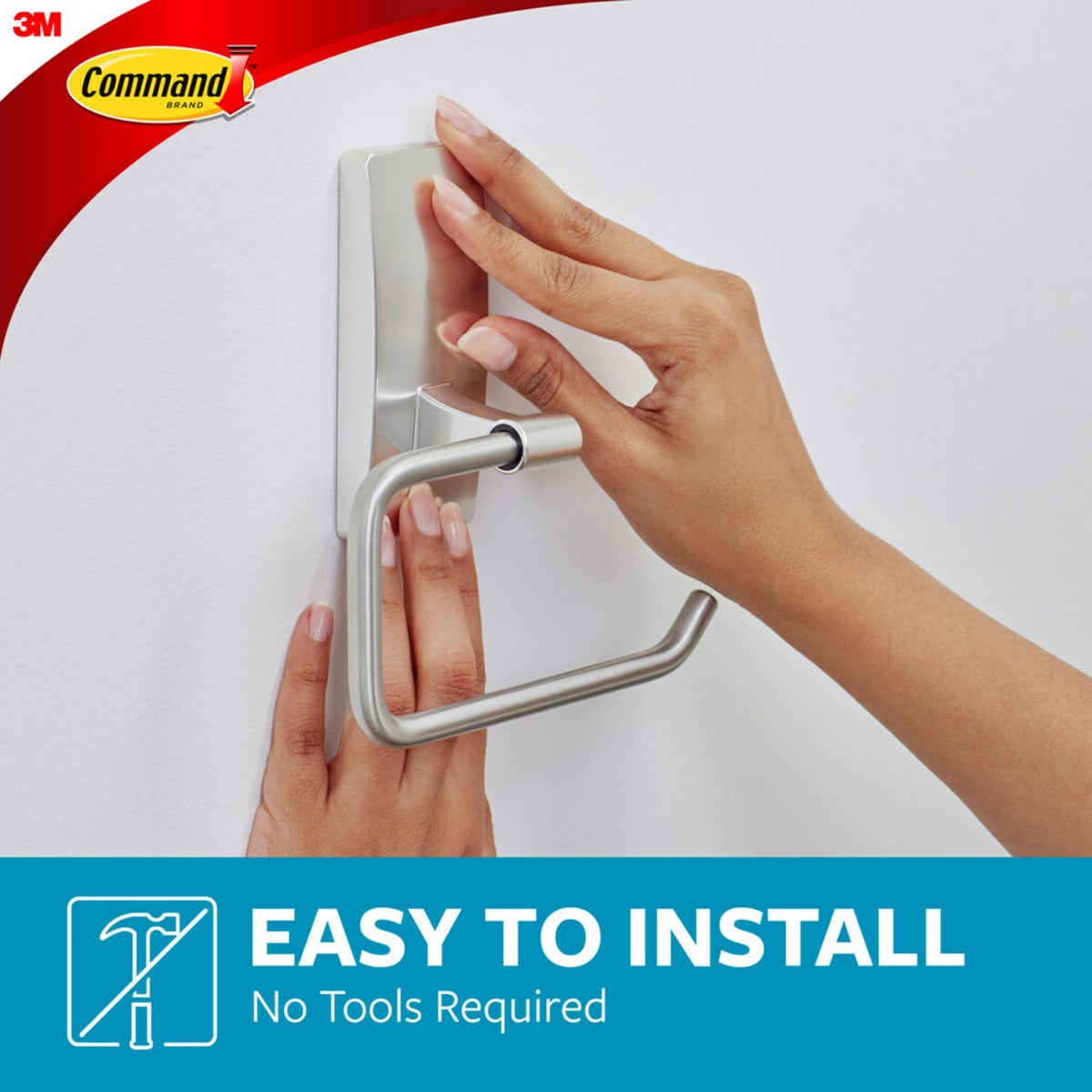 Command toilet paper holder on glass surface shows strong adhesion with rust resistance.