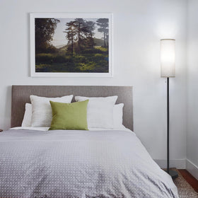 Coucrek floor lamp placed beside a sofa in a living room setup.