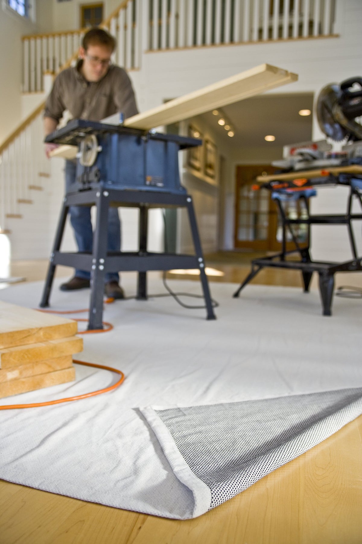 Painter using CoverGrip to protect floors during a project