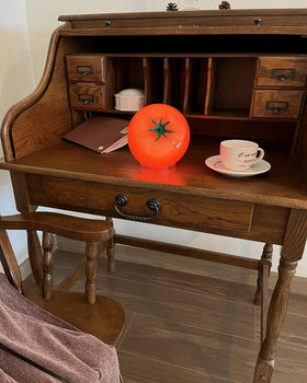 Cozifycasa glass-base tomato lamp casts cozy glow on dining or display