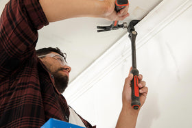 Crescent pry bar dual-material grip enhances control during prying tasks