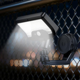 Cusna solar motion sensor light with magnetic mount on a metal fence for hands-free outdoor lighting