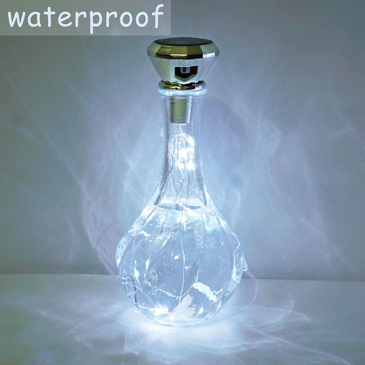 Cynzia solar wine bottle lights garden ambience shows a soft cool-white glow outdoors.