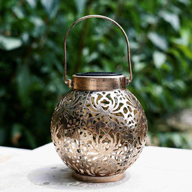 Damayca bronze solar lantern casting decorative shadows on a porch