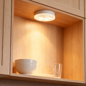 DAMI closet puck light brightens shelves for easy visibility.