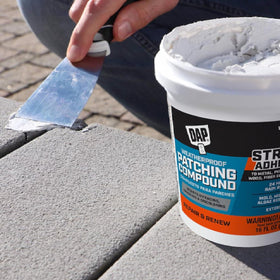 DAP Platinum Patch is spread with a putty knife for even coverage.
