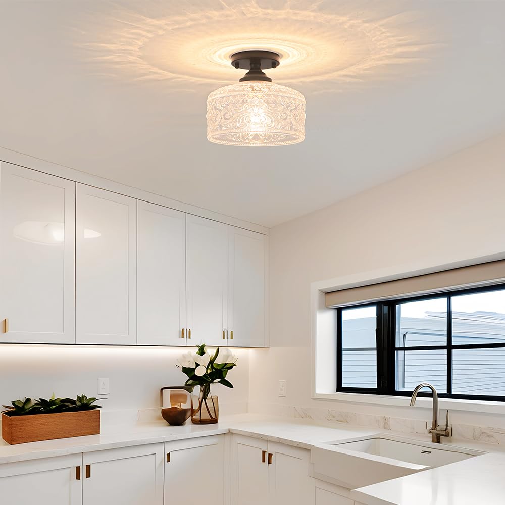 Daunton close-to-ceiling hallway light illuminating entryway with glass shade.