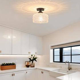 Daunton close-to-ceiling hallway light illuminating entryway with glass shade.