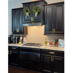 DBTHTSK gold finish push-pull handle on cabinet surface for stylish touch