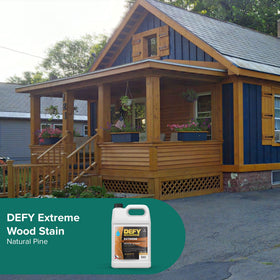 Brush applying DEFY Extreme to fence for protection
