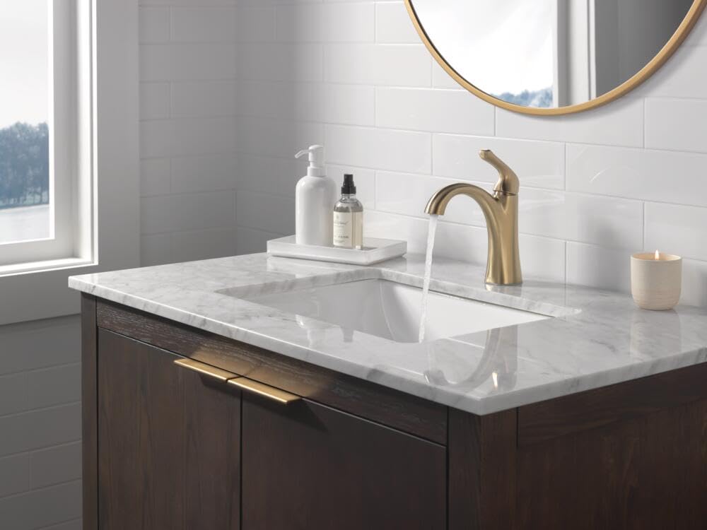 Delta Arvo brushed gold faucet close-up shows ceramic valve for smooth operation