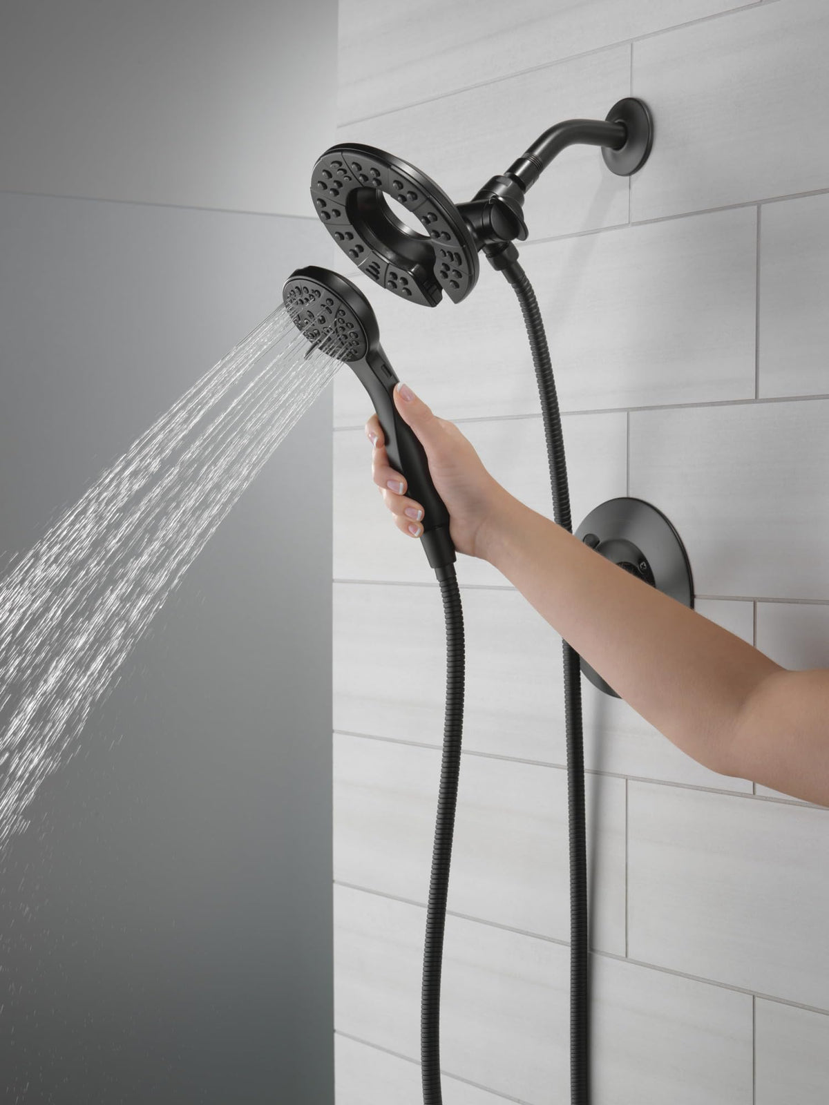 Delta Arvo In2ition dual shower head and handheld in use for versatile rinsing.