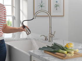 Delta Capertee pull-down-sprayer in action for easy mess cleanup