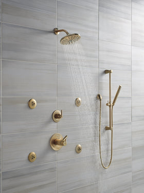 Delta champagne bronze shower elbow contributes to a cohesive, modern bathroom look