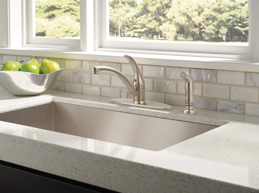Delta Foundations brushed nickel faucet with side sprayer illustrating versatile spray options for efficient cleaning.
