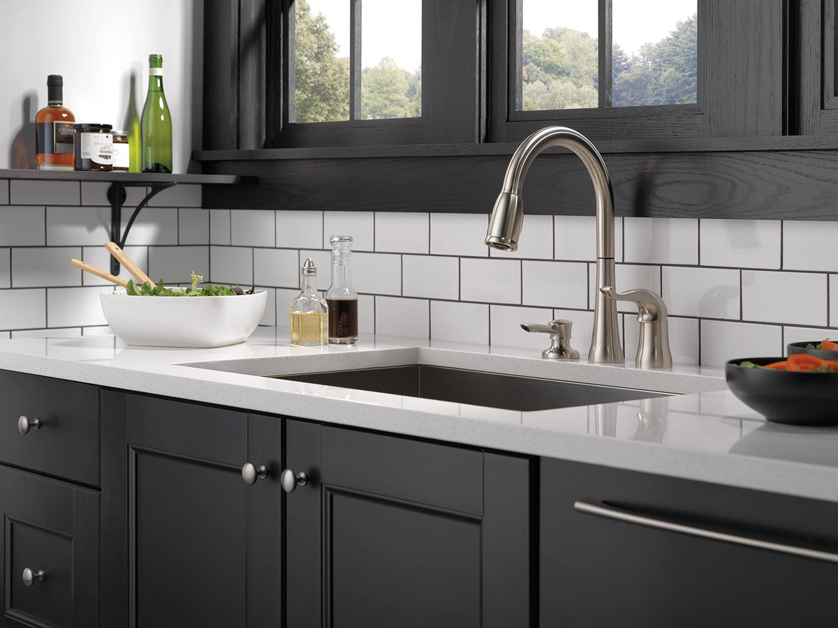 Delta Kate brushed nickel pull-down sprayer shown in action for sink tasks