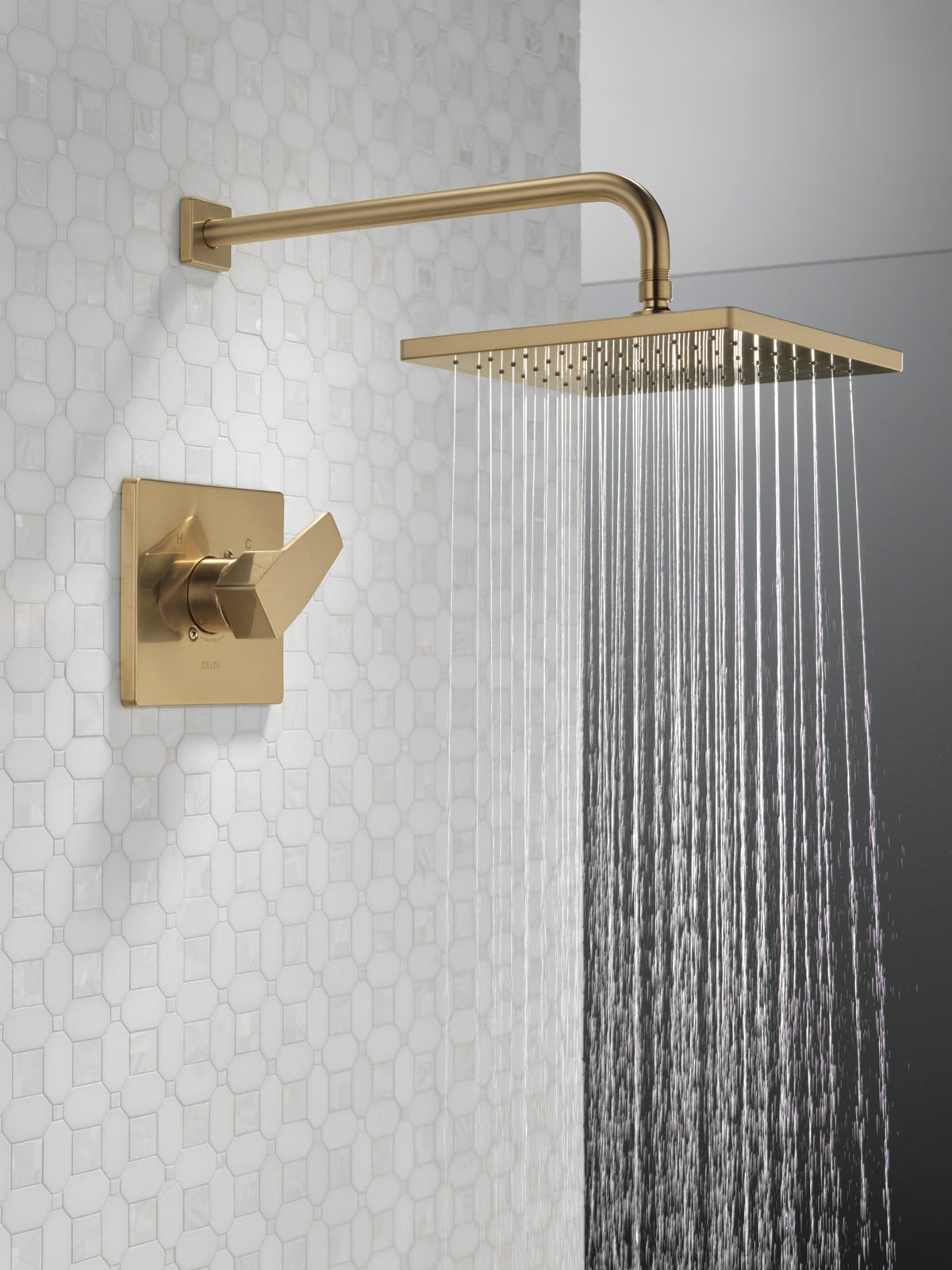 Delta Modern 14 brushed gold shower handle offers smooth grip.