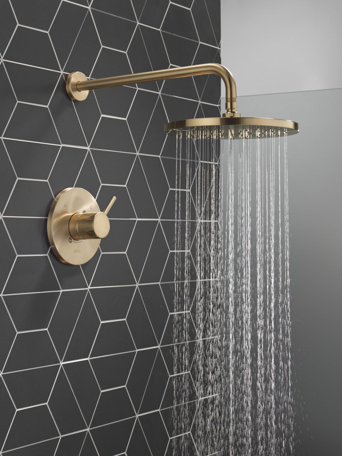 Delta Modern 14 round shower handle in brushed gold for precise control.