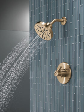 Delta Nicoli 14 Series shower handle in Brushed Gold offers precise control.