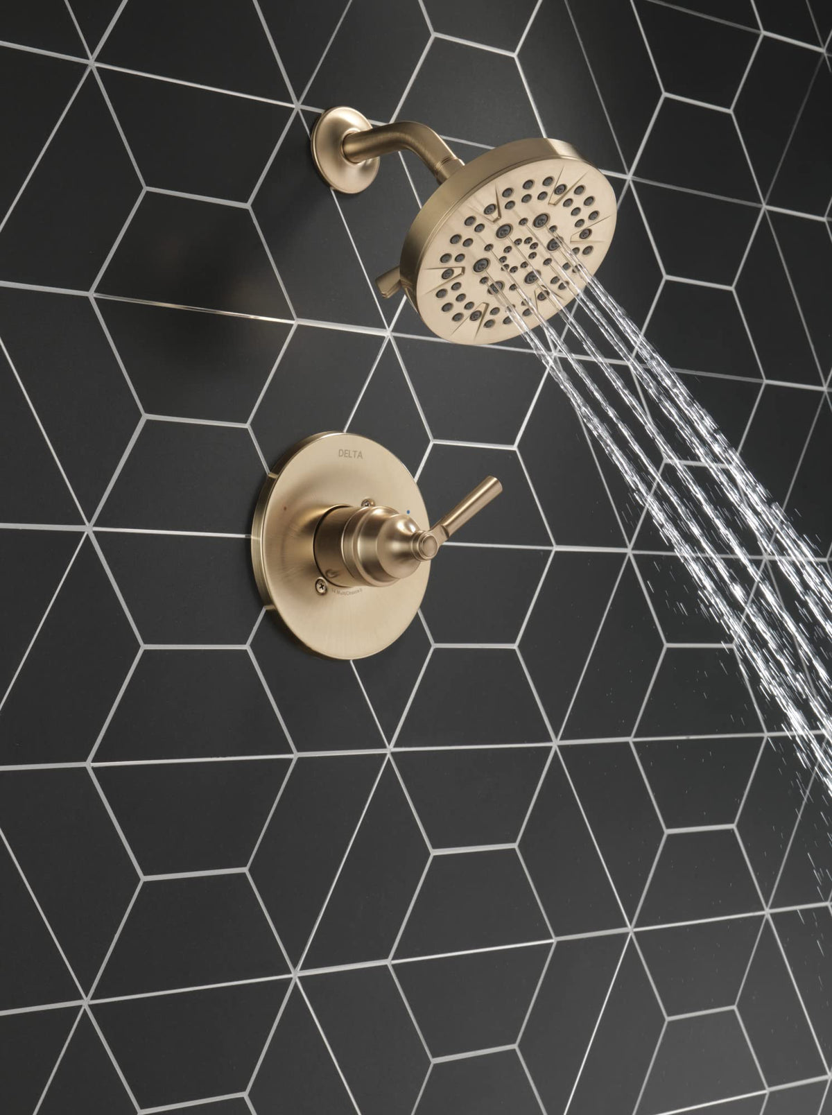 Delta Saylor brushed gold shower handle enabling precise temperature control.