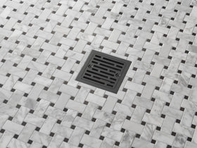 Delta matte black shower drain installed for a clean, cohesive bathroom look.
