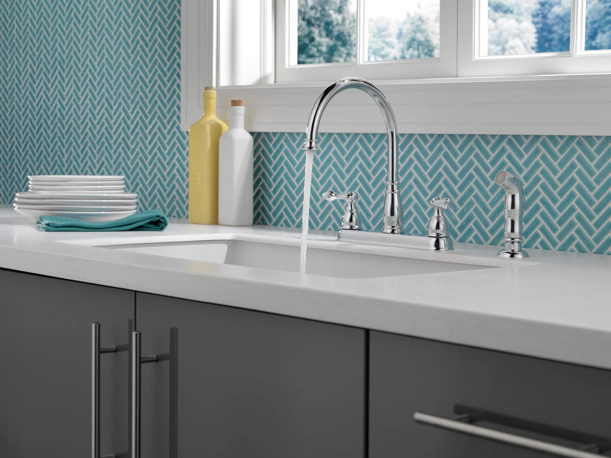 Delta Windemere chrome faucet with side sprayer in action for versatile cleaning