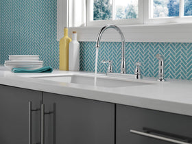 Delta Windemere chrome faucet with side sprayer in action for versatile cleaning