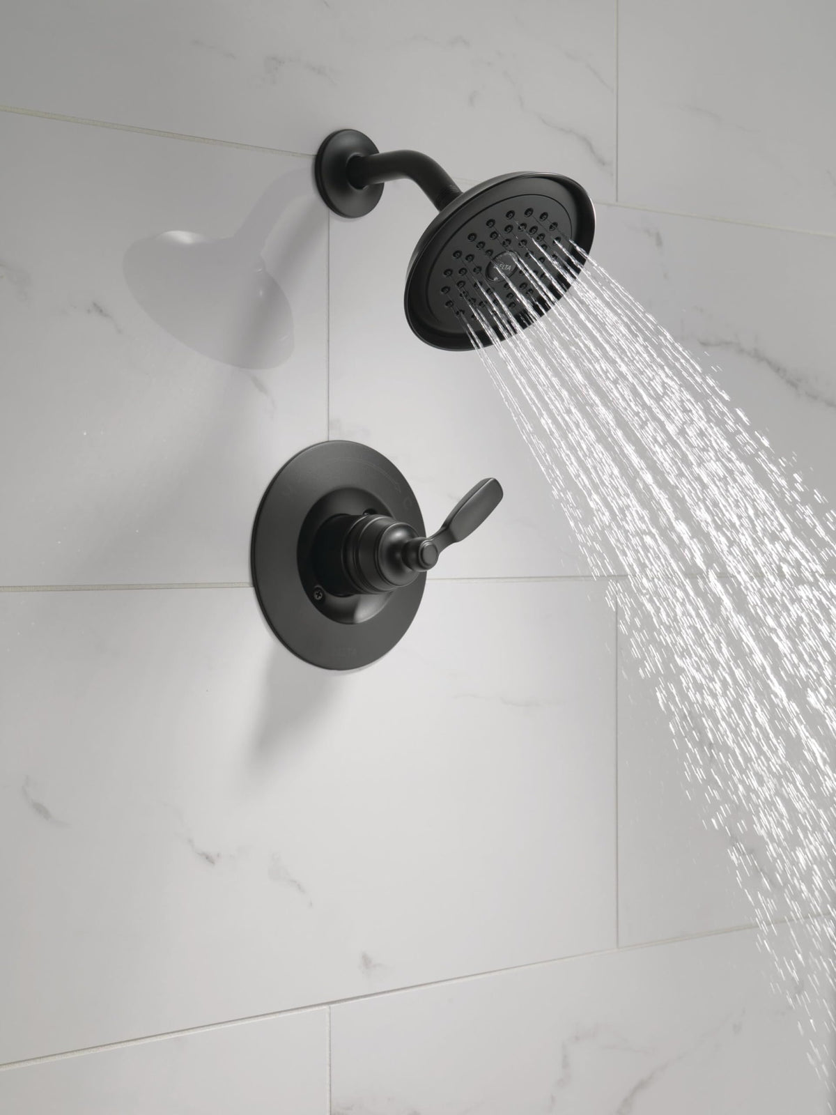 Delta Woodhurst shower handle matte black for precise water control.